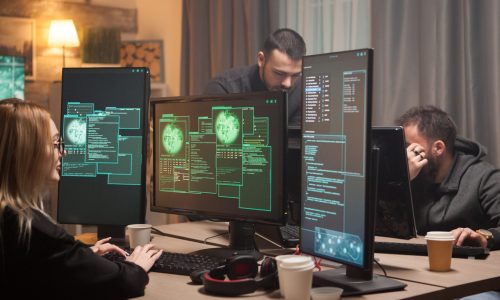 Female hacker with her team of cyber terrorists making a dangerous virus to attack the government.