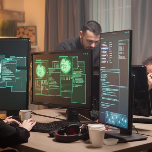 Female hacker with her team of cyber terrorists making a dangerous virus to attack the government.